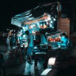 A group of people standing around a food truck