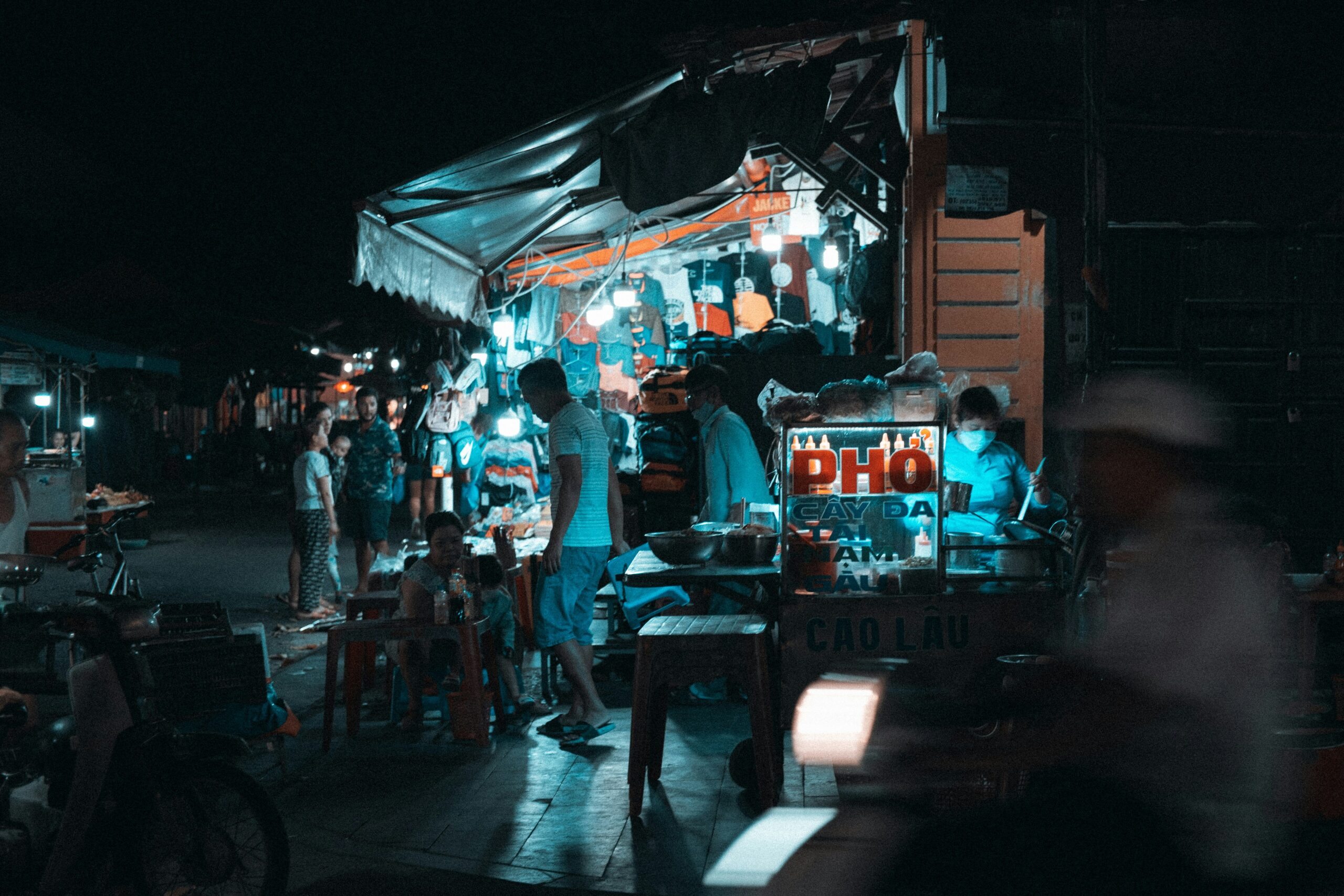 A group of people standing around a food truck